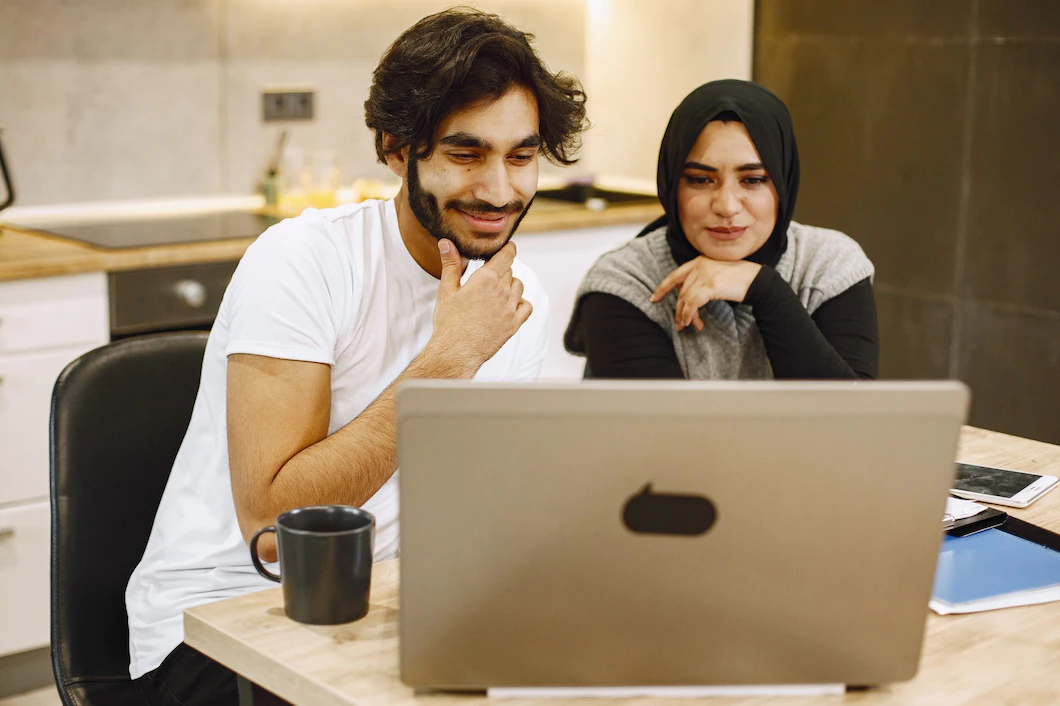 beautiful-young-couple-using-laptop-writing-notebook-sitting-kitchen-home-arab-girl-wearing-black-hidjab-1157-48423.webp beautiful-young-couple-using-laptop-writing-notebook-sitting-kitchen-home-arab-girl-wearing-black-hidjab-1157-48423.webp